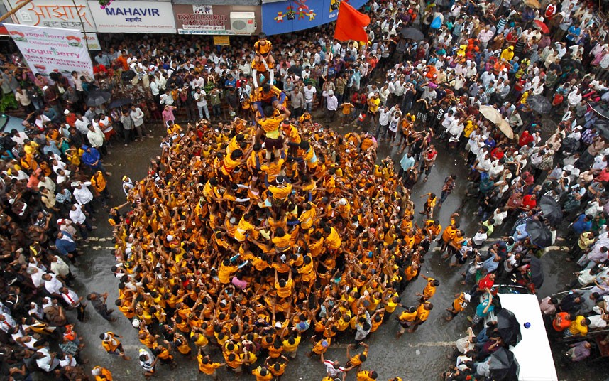 Devotees form a human pyramid to break the "Dahi handi," an earthen pot filled with curd, an integral part of celebrations to mark Janmashtami in Mumbai, India, Friday, Aug 10, 2012. Janmashtami is the festival that marks the birth of Hindu God Krishna. (AP Photo/Rafiq Maqbool)