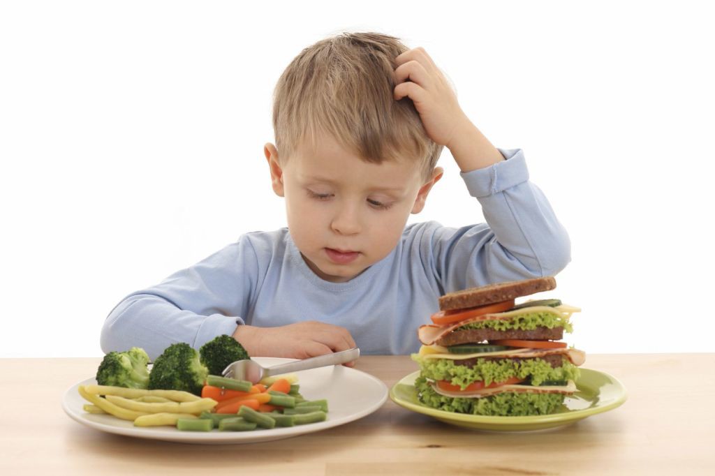 3-4 years old boy and hard choice isolated on white